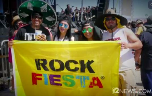 Concert goers holding Rock Fiesta flag